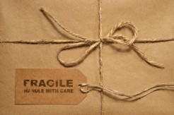 Brown shipping parcel tied with twine and tag for copy space