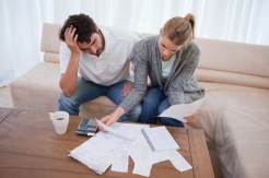 Depressed couple doing their accounting